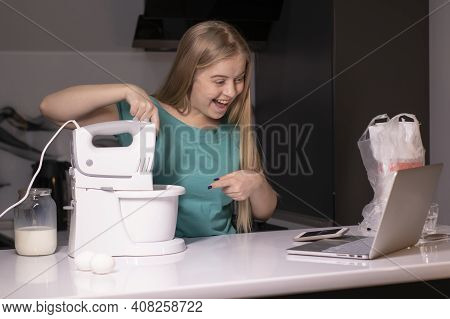 A Blonde Woman Chef Videoblogger Cooking In The Kitchen And Filming, Online Learning Or Remote Cooki