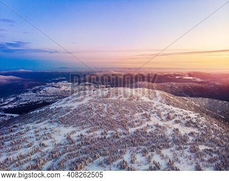 Colorful Winter Sunset In Sheregesh Ski Resort Mountains Covered Trees. Aerial Top View Beautiful Fo