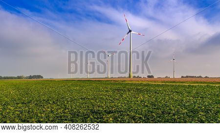 Wind Turbines In Flemish Countryside Under Blue Sky With White Clouds, Diest, Flanders, Belgium