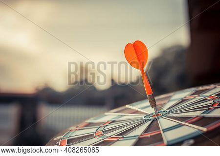 Close Up Shot Of The Dart Arrow Hit On Bulleyes Of Dartboard To Represent That The Business Reached