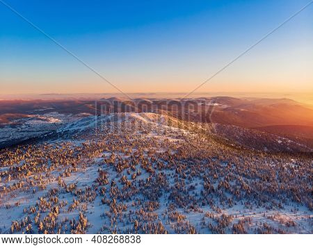 Colorful Winter Sunset In Sheregesh Ski Resort Mountains With Clouds. Aerial Top View Forest Russia