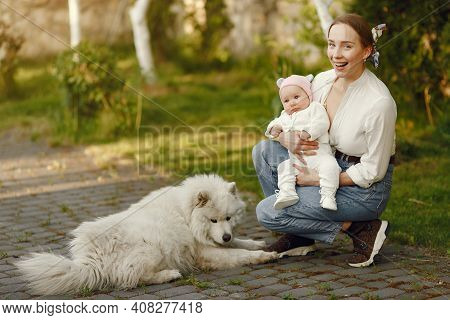 Family Spend Time In A Summer Garden
