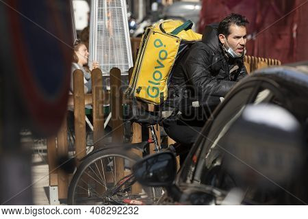 Madrid, Spain - Feb 07, 2021: Delivery People From The Home Delivery Company, Glovo, Working On The 