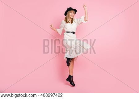 Full Length Photo Of Cheerful Lady Jump Raie Fist Wear Retro Cap Dotted Dress Footwear Isolated Pink