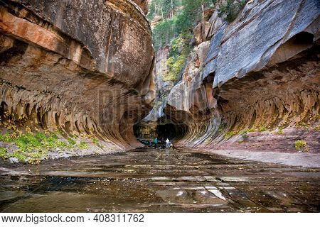 Photographers at the entrance to the Subway, a unique tunnel scuplted by the Left Fork of North Creek in Zion National Park, Utah