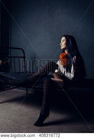 pretty girl with an old doll in an abandoned building