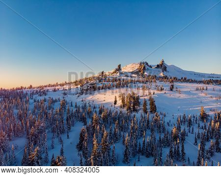 Colorful Winter Sunset In Sheregesh Ski Resort Mountains With Clouds. Aerial Top View Forest Russia