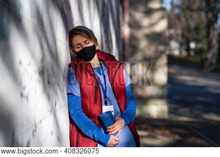 Tired Woman Caregiver Or Healthcare Worker Having A Break Outdoors, Coronavirus Concept.