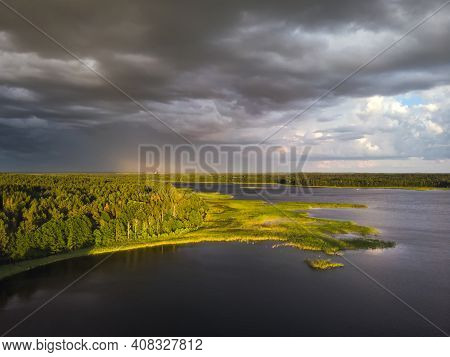 Stromy Clouds Over Eautful Peninsula Between Lakes Snudy And Strusto, National Park Braslau Lakes, B