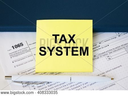 Tax Form 1065 With Yellow Sticker With Text Tax System. Notepad And White Pen