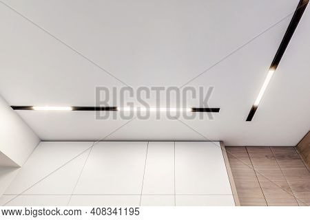 Suspended Ceiling With Halogen Spots Lamps And Drywall Construction In Empty Room In Apartment Or Ho