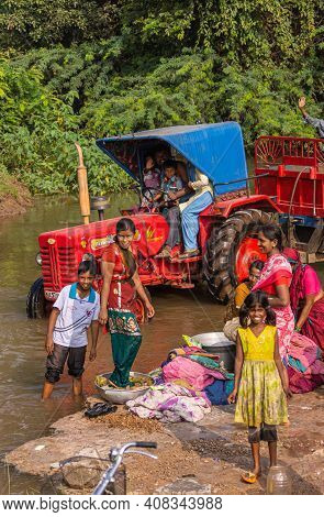 Agalkera, Karnataka, India - November 9, 2013: Happy Dad With Little Kids On Red Mahindra Tractor Wi