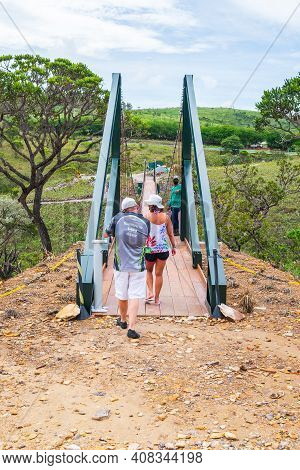 Capitólio - Mg, Brazil - December 08, 2020: Tourists Crossing The Suspension Bridge Of The Belvedere
