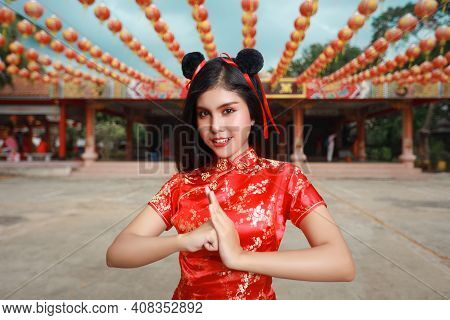 Beautiful Young Asian Woman In Red Chinese Dress Traditional Cheongsam Qipao With Gesture Of Congrat