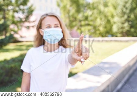 Young Woman Wearing Protective Mask Outdoors. Medicine Equipment. Pandemic Safety Concept. White T-s