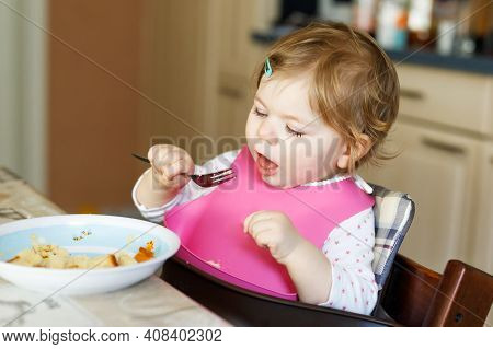 Adorable Baby Girl Eating From Spoon Mashed Vegetables And Puree. Food, Child, Feeding And People Co