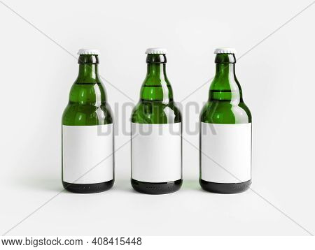 Three Green Beer Bottles With Blank Labels.