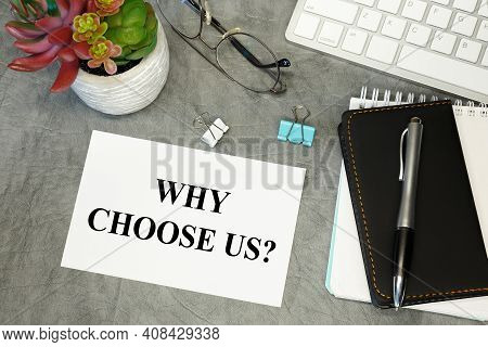 Why Choose Us - Lettering On Paper On The Desktop, Notepad, Pen And Keyboard. Concept Photo Of The A
