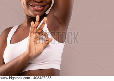 Unrecognizable Smiling Black Lady Demonstrating Her Smooth Clean Armpit And Showing Ok Gesture, Reco
