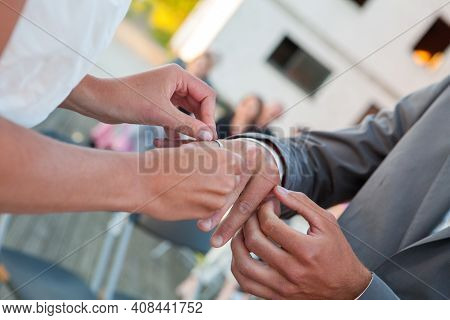 Bride And Groom Exchanging Wedding Rings. Stylish Couple Official Ceremony. High Quality Photo