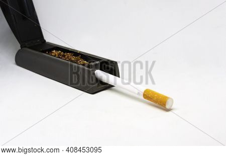 Cigarette Maker Machine With Tobacco And An Empty Cigarette Tube Ready To Be Filled