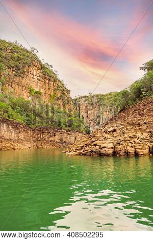 Beautiful Landscape Of Canyons During Sunset, Big Walls Of Sedimentary Rocks And A Lake With Green W