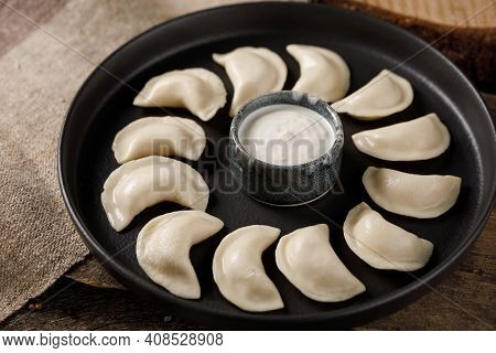 Appetizing Traditional Russian Dumplings, Hand-made With Potatoes. Still Life On A Wooden Board. Clo