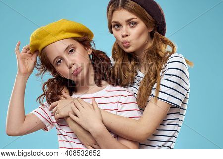 Mom And Daughter Striped T-shirts Hugs Fun Lifestyle Blue Background