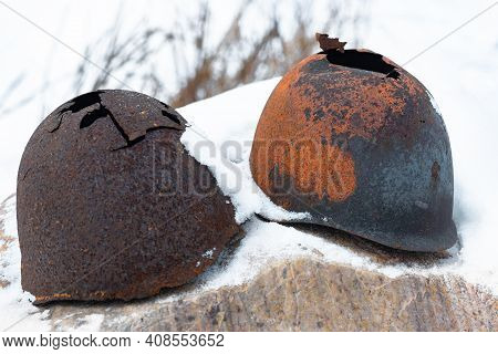Old Broken Helmets Soviet World War On Snow Stone Remained In Russian Federation