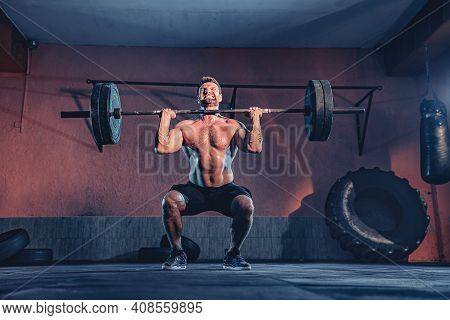 Muscular Fitness Man Doing Push A Barbell Over His Head In Modern Fitness Center. Functional Trainin