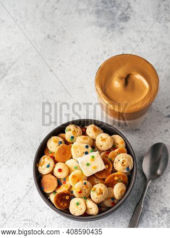 Mini Pancakes Cereal And Dalgona Coffee On Gray Cement Background, Copy Space. Trendy Food And Drink