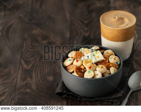 Mini Pancakes Cereal And Dalgona Coffee On Brown Wooden Background, Copy Space. Trendy Food And Drin