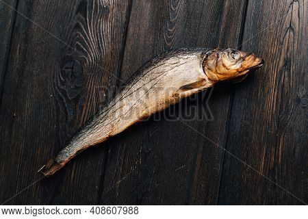Dried Fish Lies On A Wooden Table Top View Texture