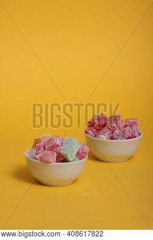 Two Bowls Of Rahat Lakoum Isolated On Yellow Background. Turkish Sweet Concept. Image Contains Copy 