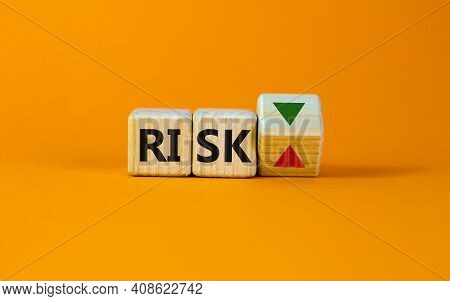 Risk Symbol. Wooden Cube With Word 'risk'. Turned The Wooden Cube, Changes The Direction Of An Arrow