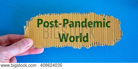Post-pandemic World Symbol. Concept Words 'post-pandemic World' On Cardboard Between Fingers. Beauti
