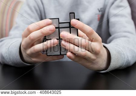Dnipro, Ukraine - May 11, 2020 - Boy Solving Mirror Cube. Child Hands With Cube Puzzle. Close Shot.