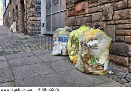 Witten, Germany - September 16, 2020: Sorted Household Waste In Yellow Bags Waiting For Pick Up In D