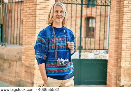 Young scandinavian tourist man smiling happy at the city.