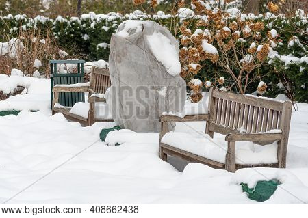 Plants And Trees In A Park Or Garden Covered By The Snow And Blanket, Swath Of Burlap, Frost Protect