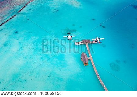 Beautiful Aerial View Of Maldives Jetty Seaplane Top View With Wooden Boat Dhoni And Tropical Beach,