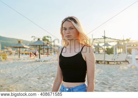 Outdoor Portrait Of 16 Year Old Female Teenager. Beautiful Serious Looking At Camera Woman With Wet 