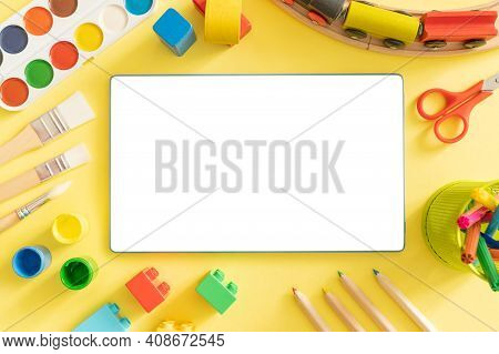 Online Day Care Cover Concept - Toys And Supplies With Isolated Tablet, Top View