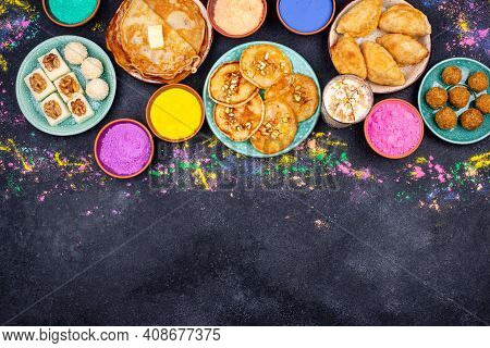 Traditional Indian Festival Food And Gulal Colors. Happy Holi Concept.