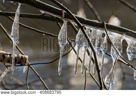 Light Reflected Through Icicles At A River In Winter Time