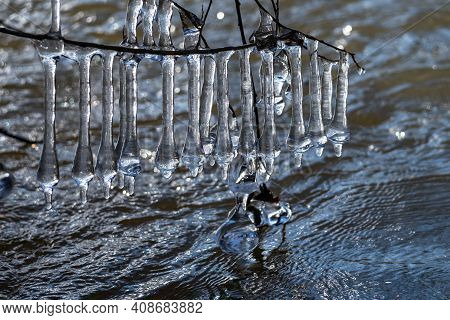 Light Reflected Through Icicles At A River In Winter Time