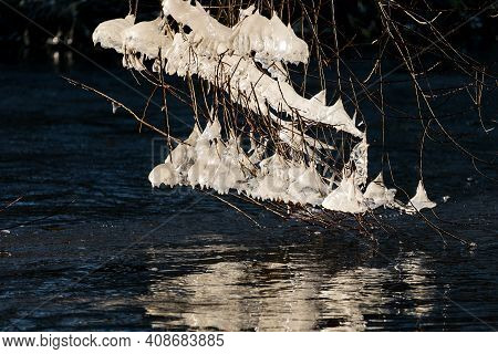 Light Reflected Through Icicles At A River In Winter Time
