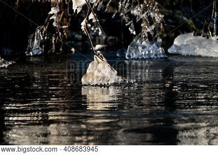 Light Reflected Through Icicles At A River In Winter Time
