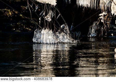 Light Reflected Through Icicles At A River In Winter Time