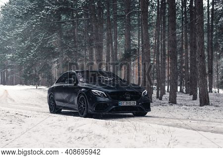 Kherson, Ukraine - February 2021. Powerful Mercedes-amg E63s Brabus 800 In A Black Color In The Wint